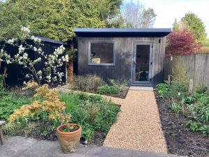 corten steel edging separating gravel path from planted borders