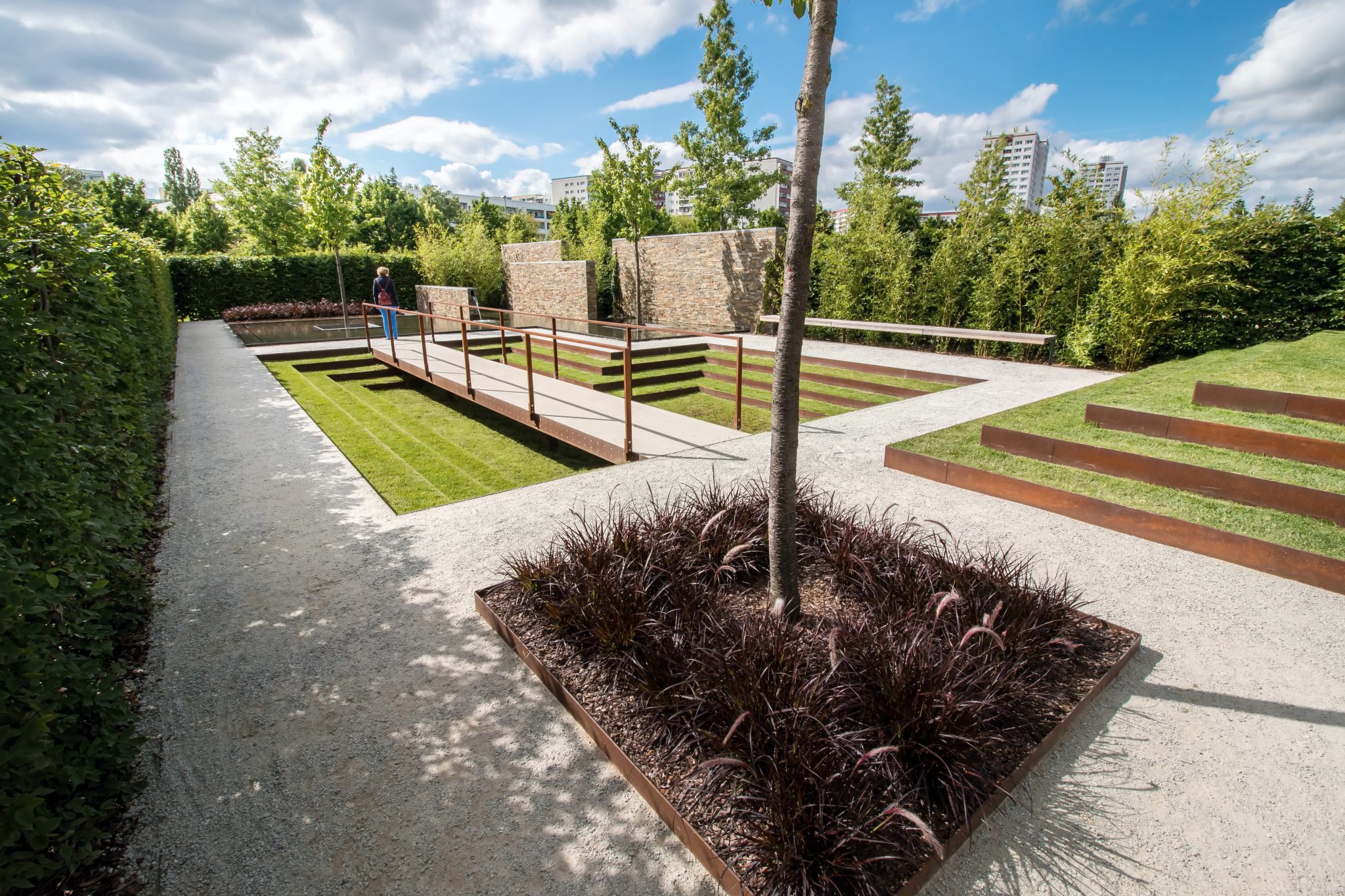 Stepped garden terraces retained by steel edging on a gentle slope