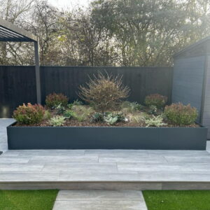 Powder coated trough planter set inside decking