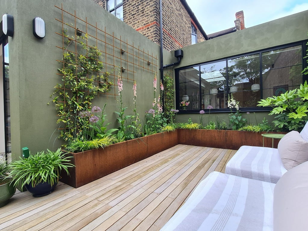 long corten steel trough planter planted in contemporary courtyard garden