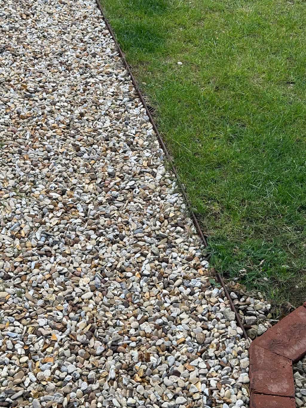 Steel edging with gravel border Corten steel edging forming a gravel border